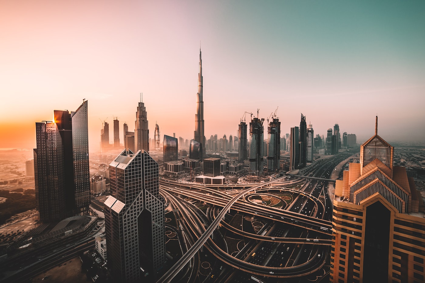 The Burj Khalifa towering over the futuristic Dubai skyline at sunset