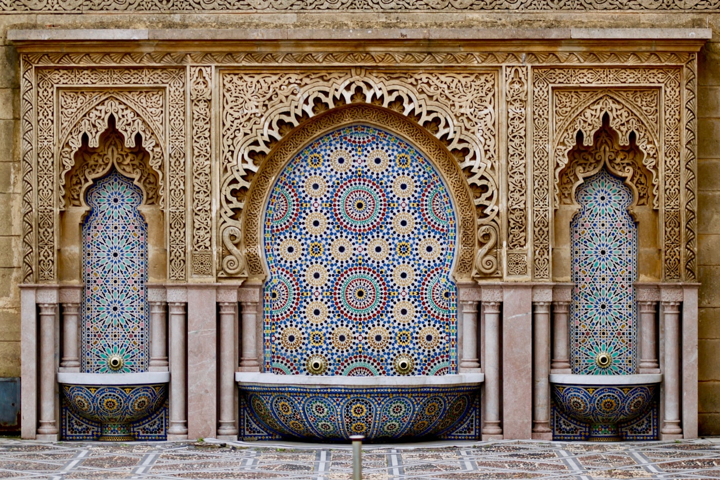 Intricate mosaic tiles and vibrant colors of a traditional Moroccan riad courtyard