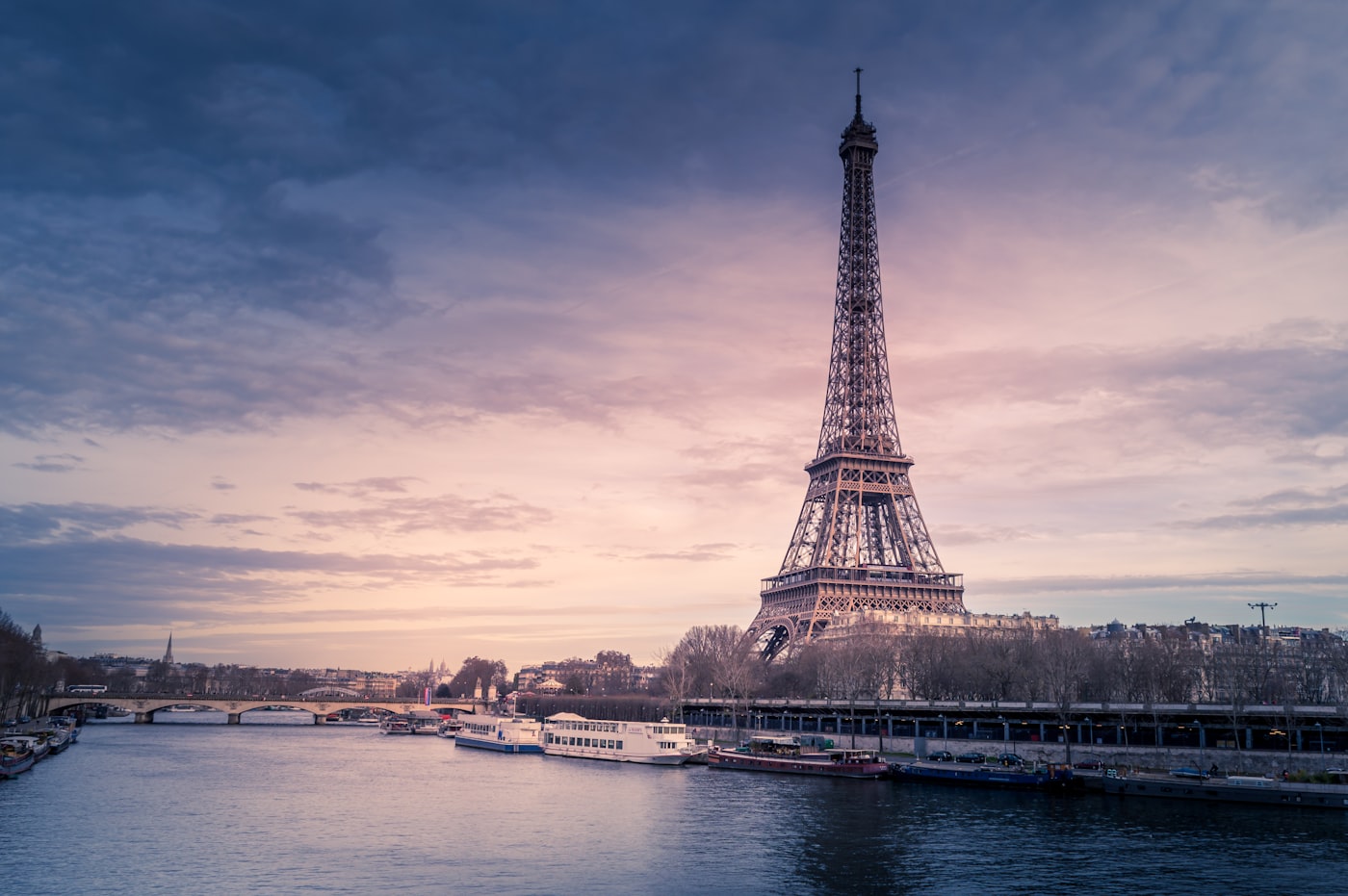 Eiffel Tower viewed from Trocadero square at sunset with soft pink sky