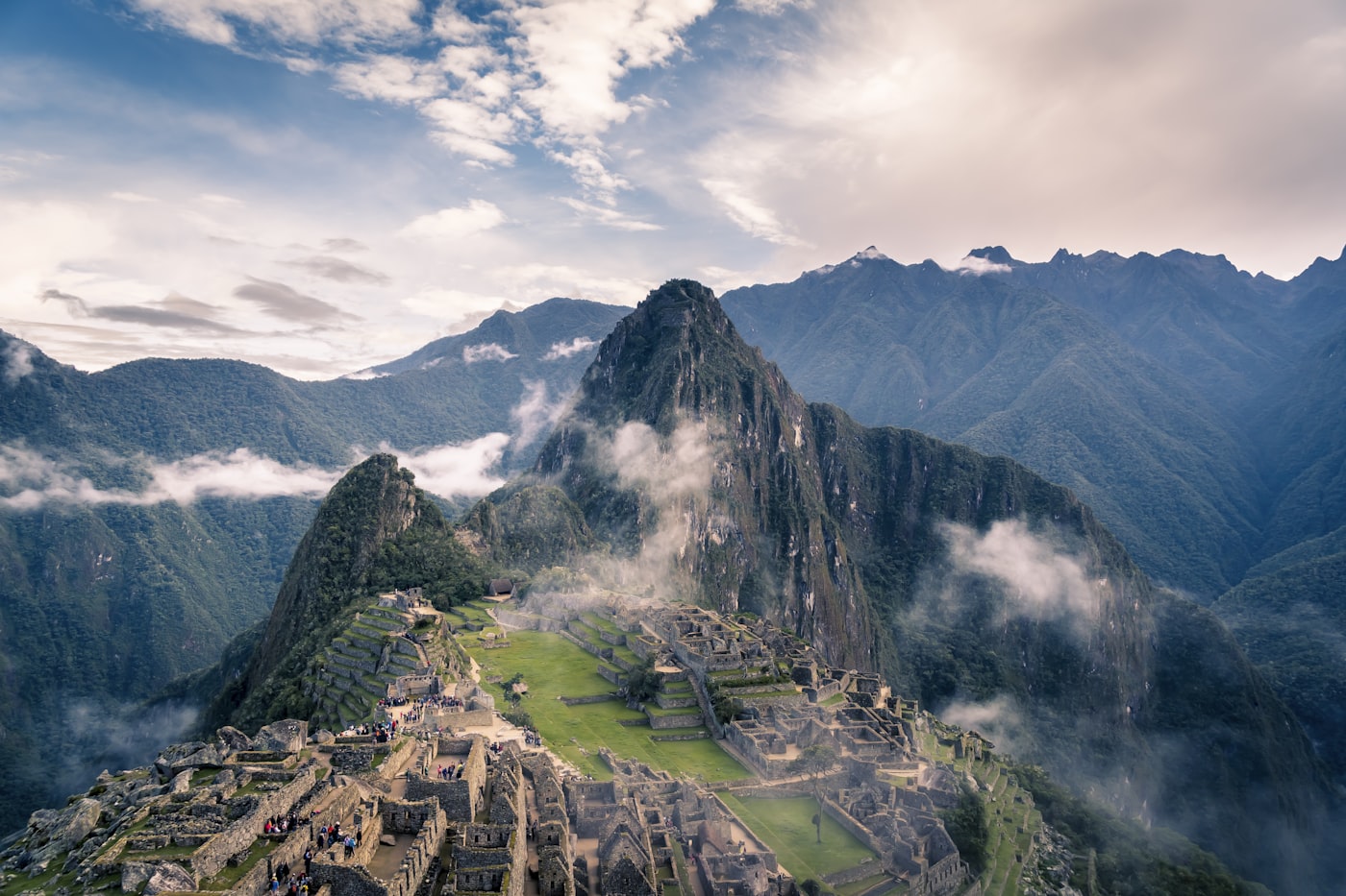 Machu Picchu glowing in the morning sun with mist over the Andes mountains