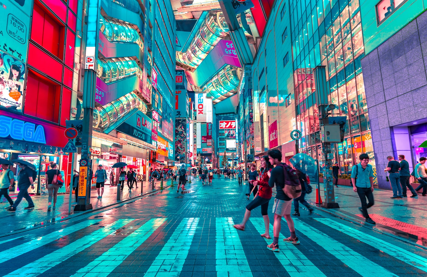 The neon-drenched bustling streets and massive pedestrian scramble of Shibuya at night